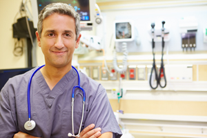 This is a picture of a nurse in a hospital room smiling